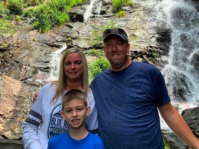 family photo with waterfall in background